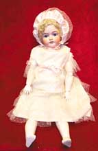 a%20doll%20wearing%20a%20white%20dress%20and%20bonnet